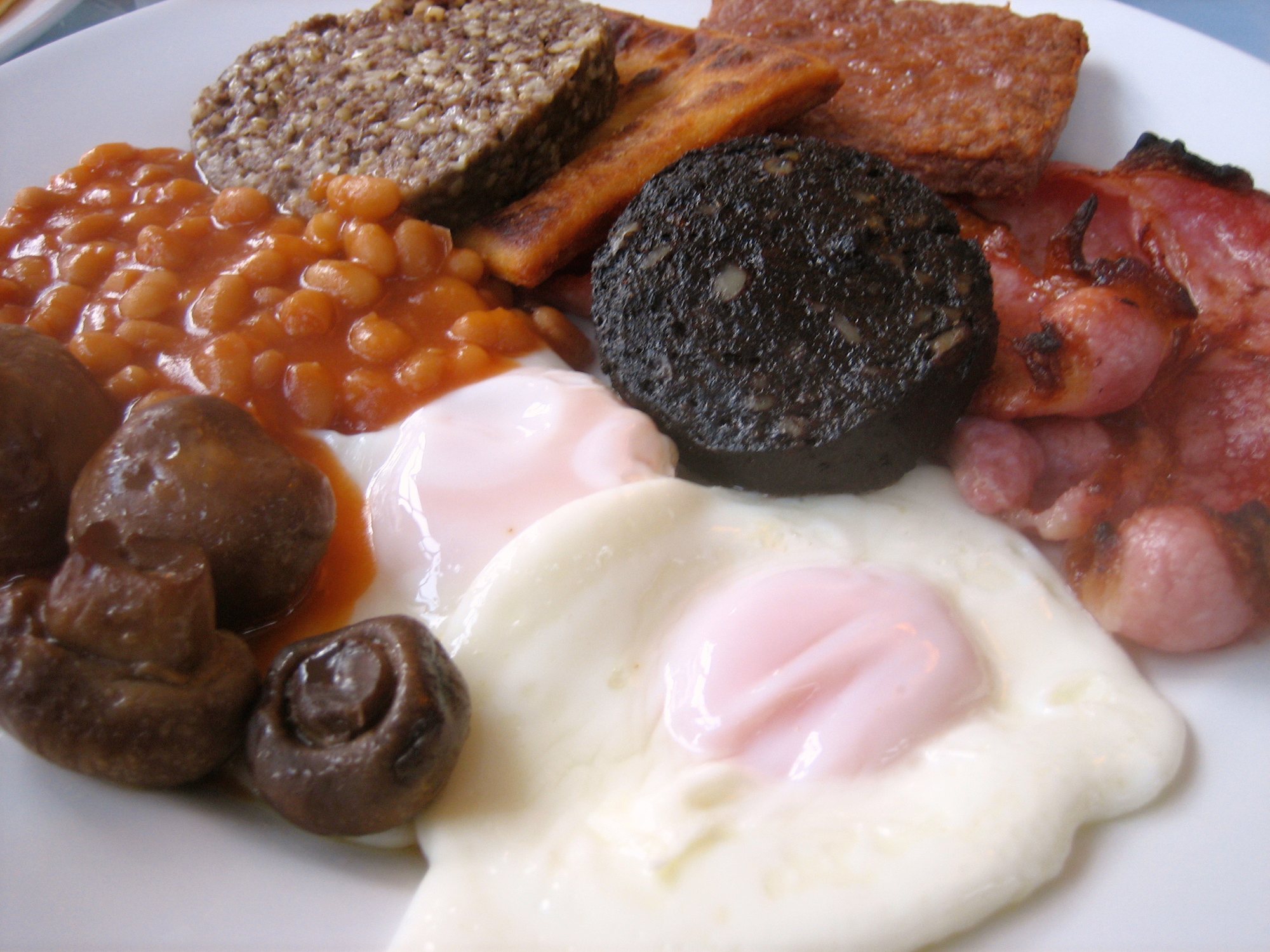 A full Scottish breakfast: square sausage, black pudding, bacon, egg, beans and a potato scone